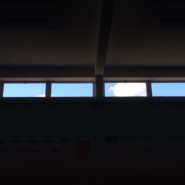 thin windows let in a sliver of blue sky