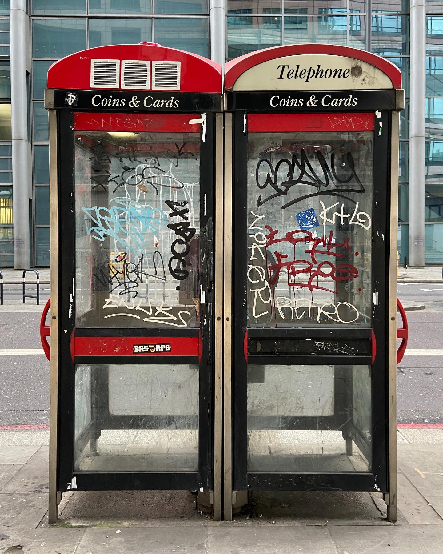 twin phone booths boasting coins & cards