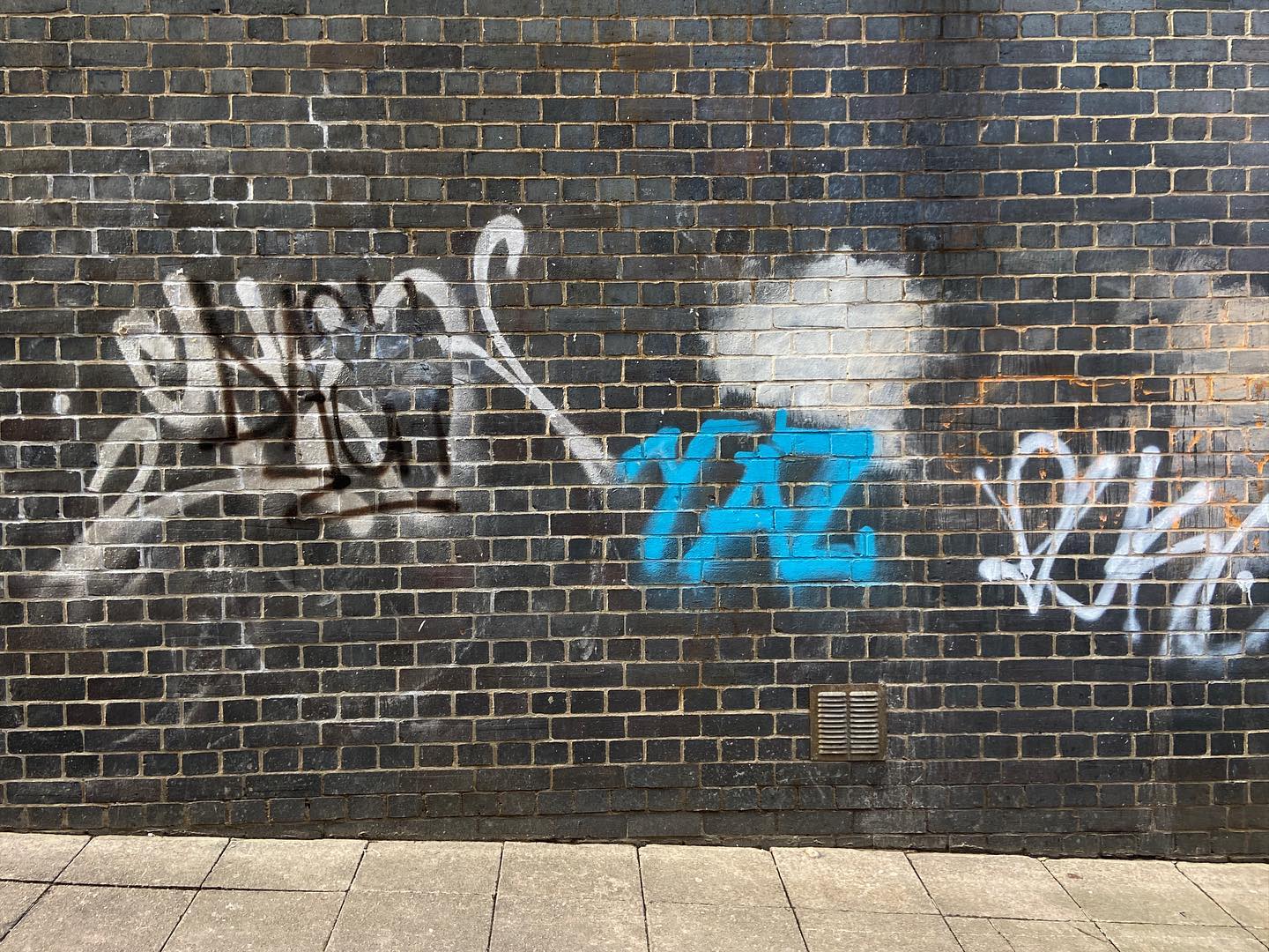 black brick with white mortar, clouded with tags on tags. light blue YAZ front and centre